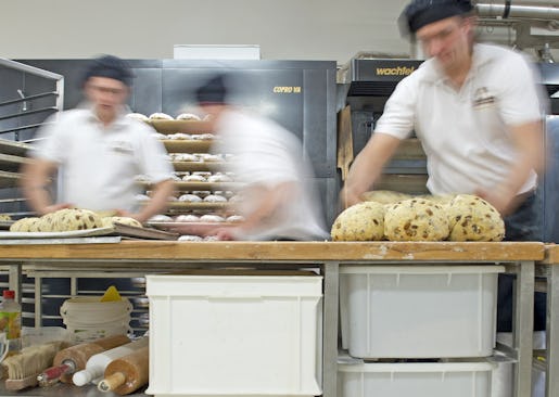 Workers form dough for the Christmas cake Original Dresdner Christstollen (Dresden Stollen) in the Morenz bakery in Dresden, eastern Germany, Thursday, Nov. 21, 2013. The stollen cakes contain dried fruit and are covered with sugar, usually eaten during the Christmas season. The Morenz bakery belongs to the German Association for the Protection of the Dresden Christmas Stollen which allows bakeries to produce and sell this cakes worldwide under the registered trademark"Echter Dresdner Christstollen". (AP Photo/Jens Meyer)