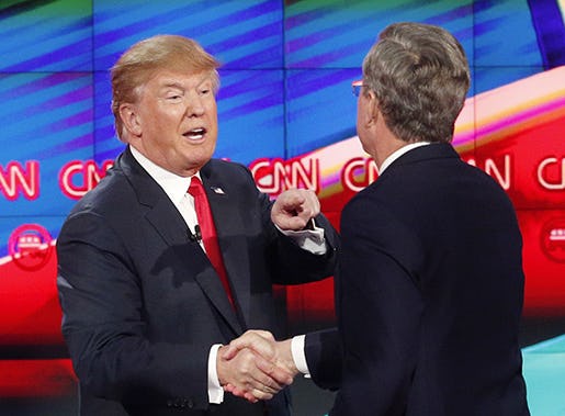 Donald Trump, left, and Jeb Bush talk together following the CNN Republican presidential debate at the Venetian Hotel & Casino on Tuesday, Dec. 15, 2015, in Las Vegas. (AP Photo/John Locher)
