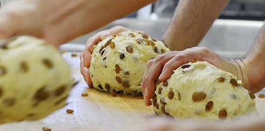 Workers form dough for the Original Dresdner Christstollen cake (Dresden Christmas Stollen) in the bakery Wippler in Dresden, eastern Germany, Monday, Nov. 12, 2012. The company has orders for cakes from European countries as well as the US , Australia, China and Japan. The family business has been running for over 100 years (AP Photo/Jens Meyer)