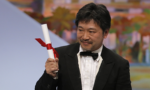 Director Kore-eda Hirokazu holds up the Jury's Prize award for his film Like Father, Like Son which was presented by actress Rossy de Palma during an awards ceremony at the 66th international film festival, in Cannes, southern France, Sunday, May 26, 2013. (AP Photo/Francois Mori)