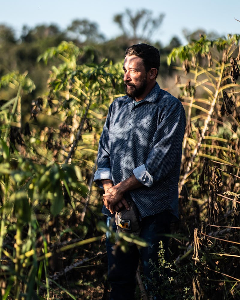 Landless farmer Nestor Castro stands in a field.