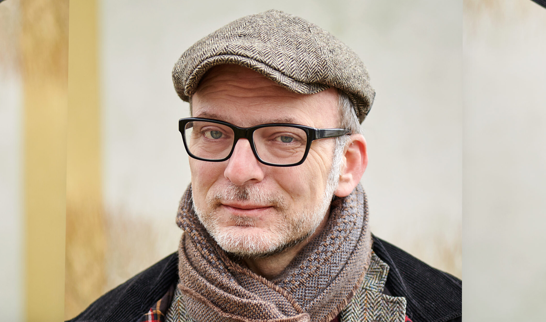 En man med glasögon och hatt.