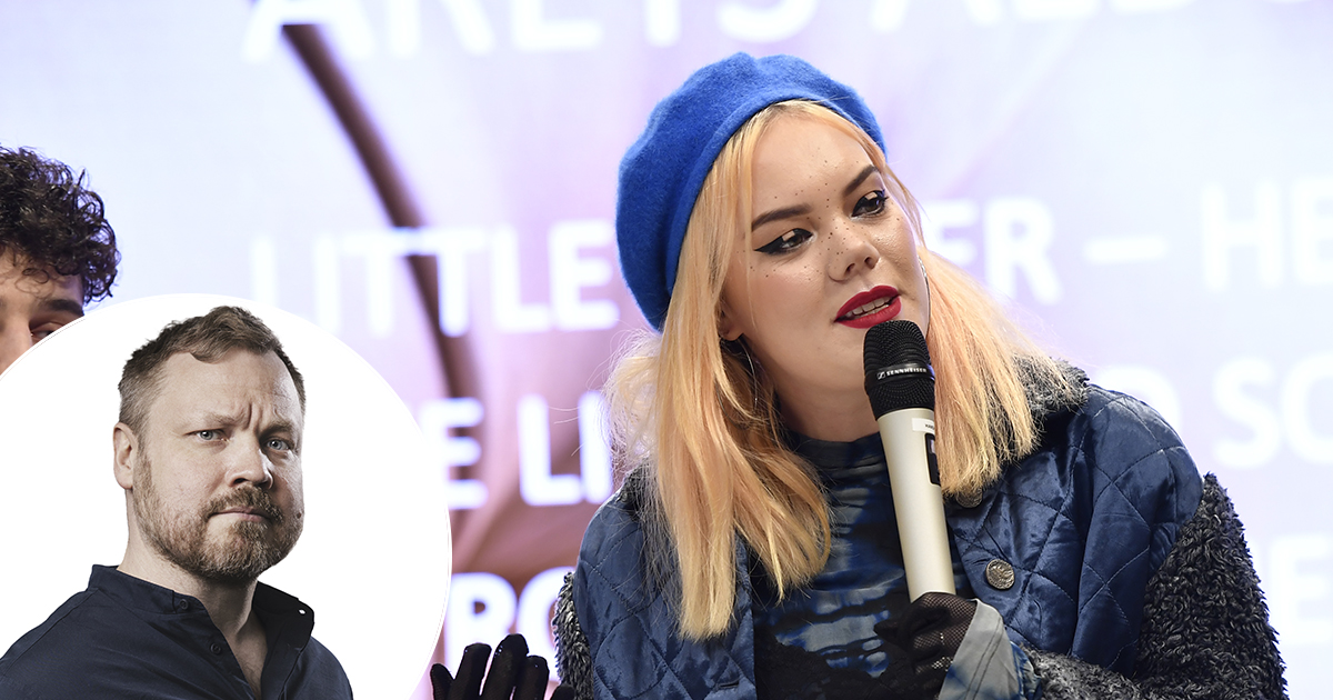 En man med skägg och en kvinna som håller i en mikrofon.