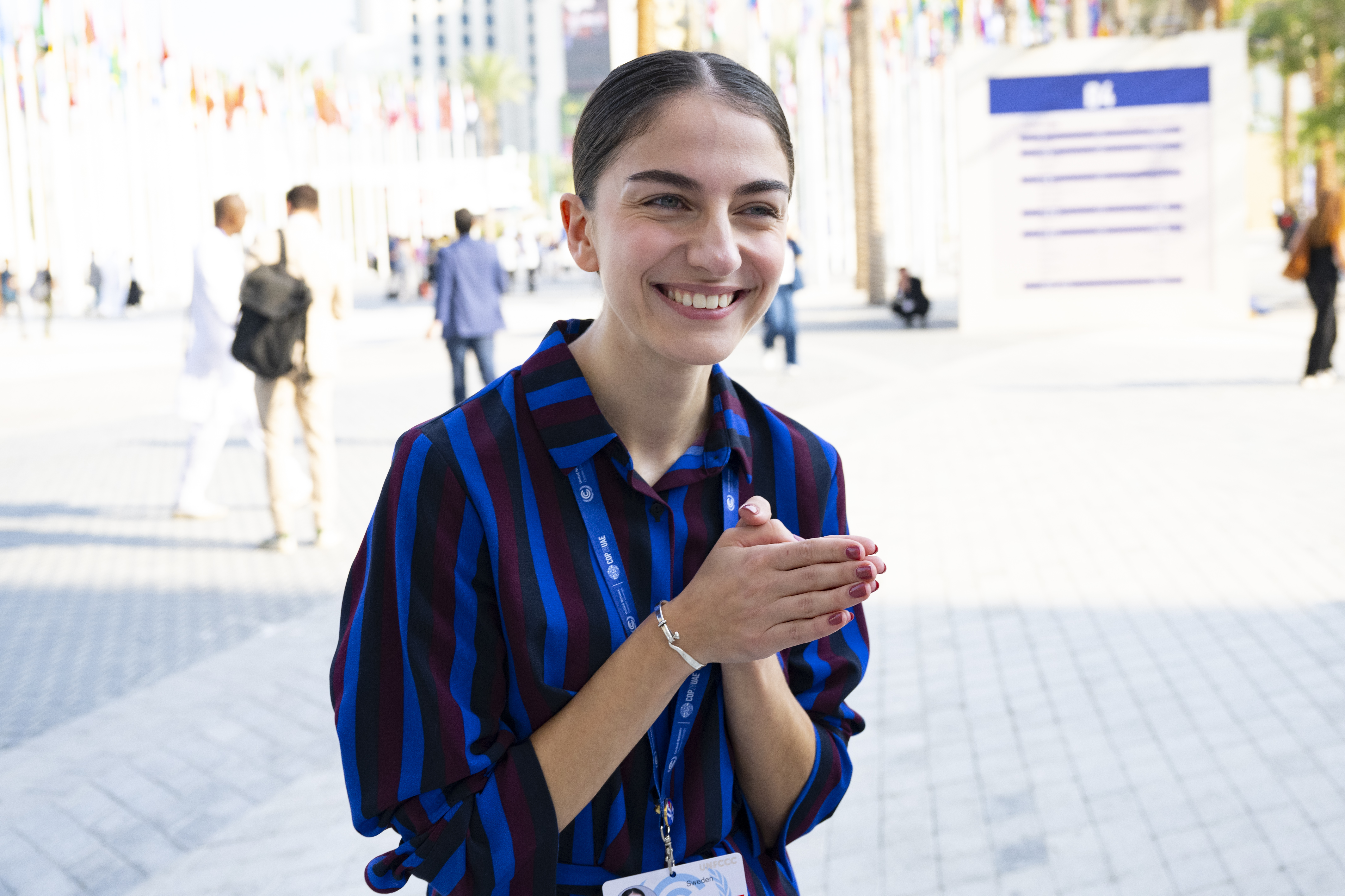 En ung kvinna i randig skjorta poserar för ett foto.