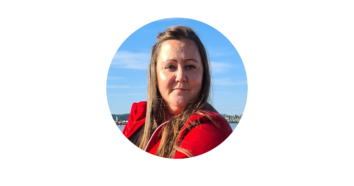 En kvinna i en röd skjorta med en blå bakgrund.