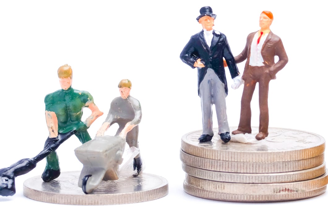 A picture of workplace discrimination concept with miniature and stack of money. The harder you work, the more I earn refer to CEO and Bosses.