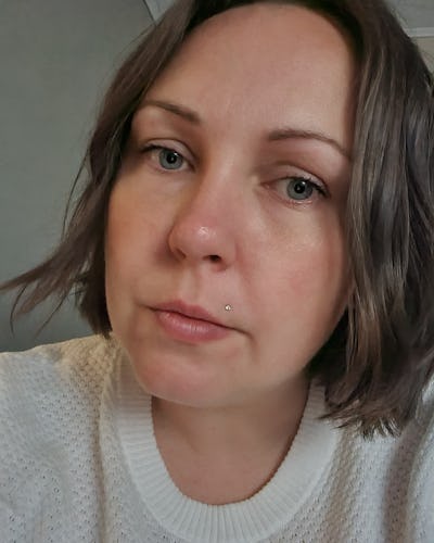 Porträtt på Nina Persson som tittar rakt in i kameran med neutralt ansiktsuttryck.