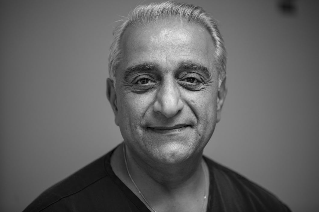 Porträtt i svartvitt av Ahmed Alneaimi med kort grått hår, klädd i en mörk skjorta och ett lätt riktat mot kameran.