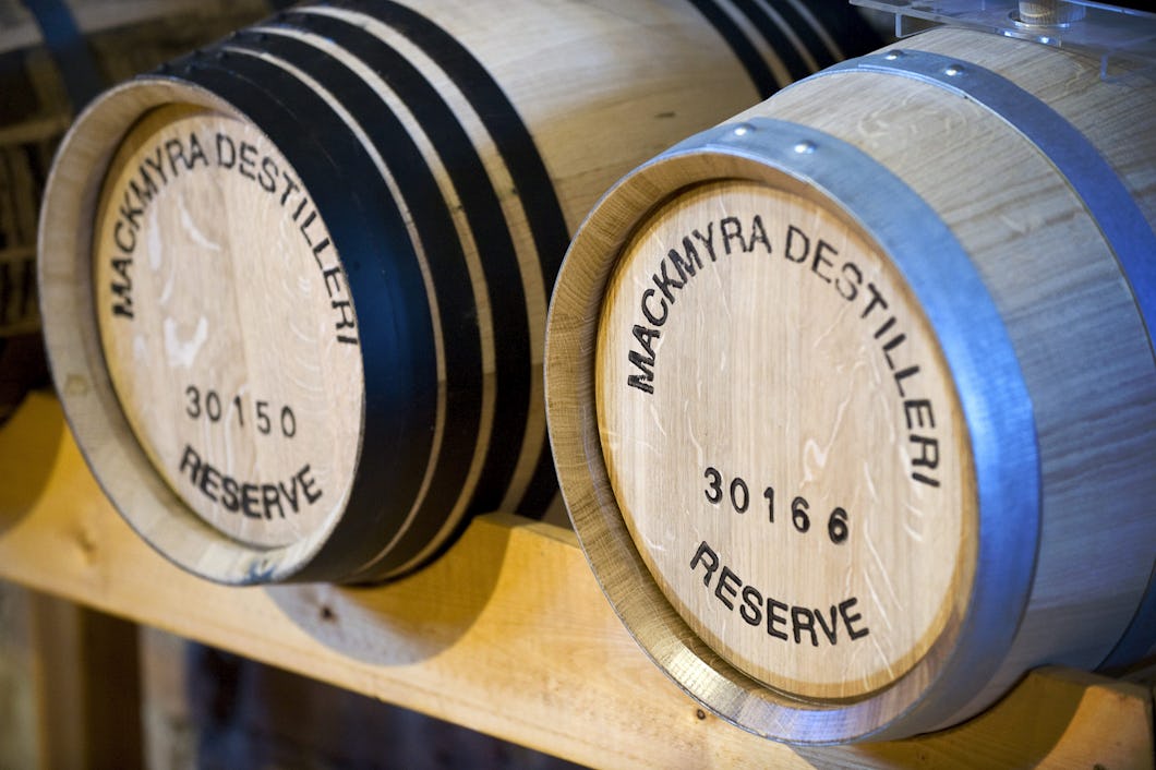 Två trätunnor med texten "Mackmyra Destilleri Reserve" och numren 30150 och 30166 stämplade på ändarna, placerade på ett träställ.