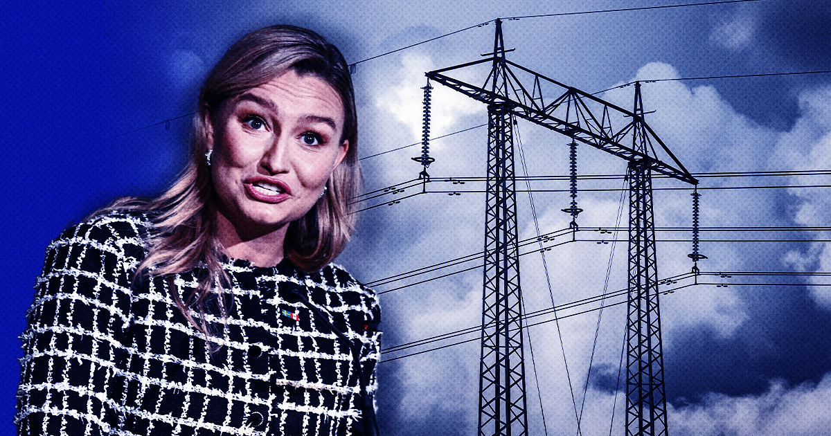 Ebba Busch talar. Inklippt med en elnätsledning och en molnig himmel i bakgrunden.