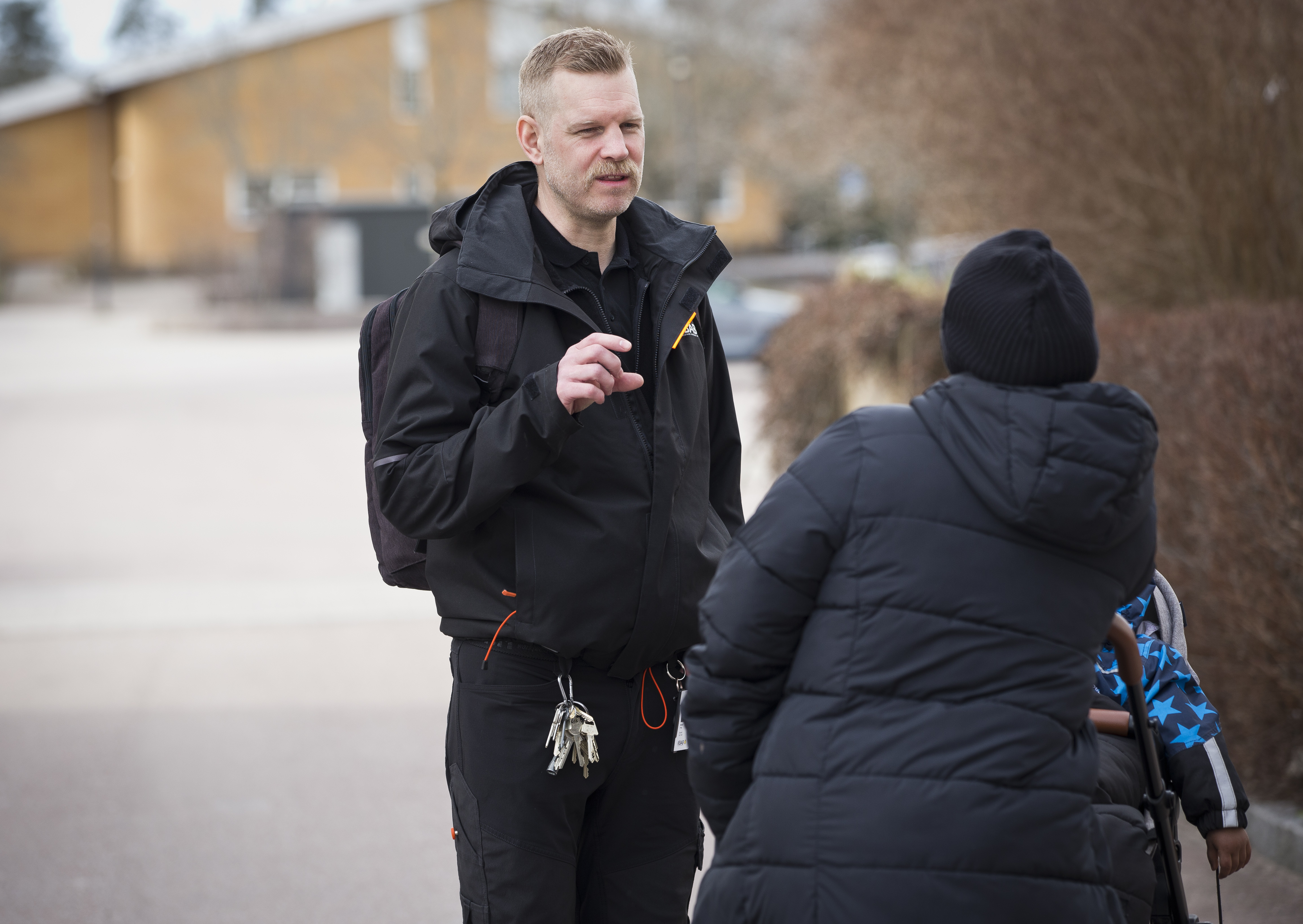 Michael Frey pratar med en annan person utanför.