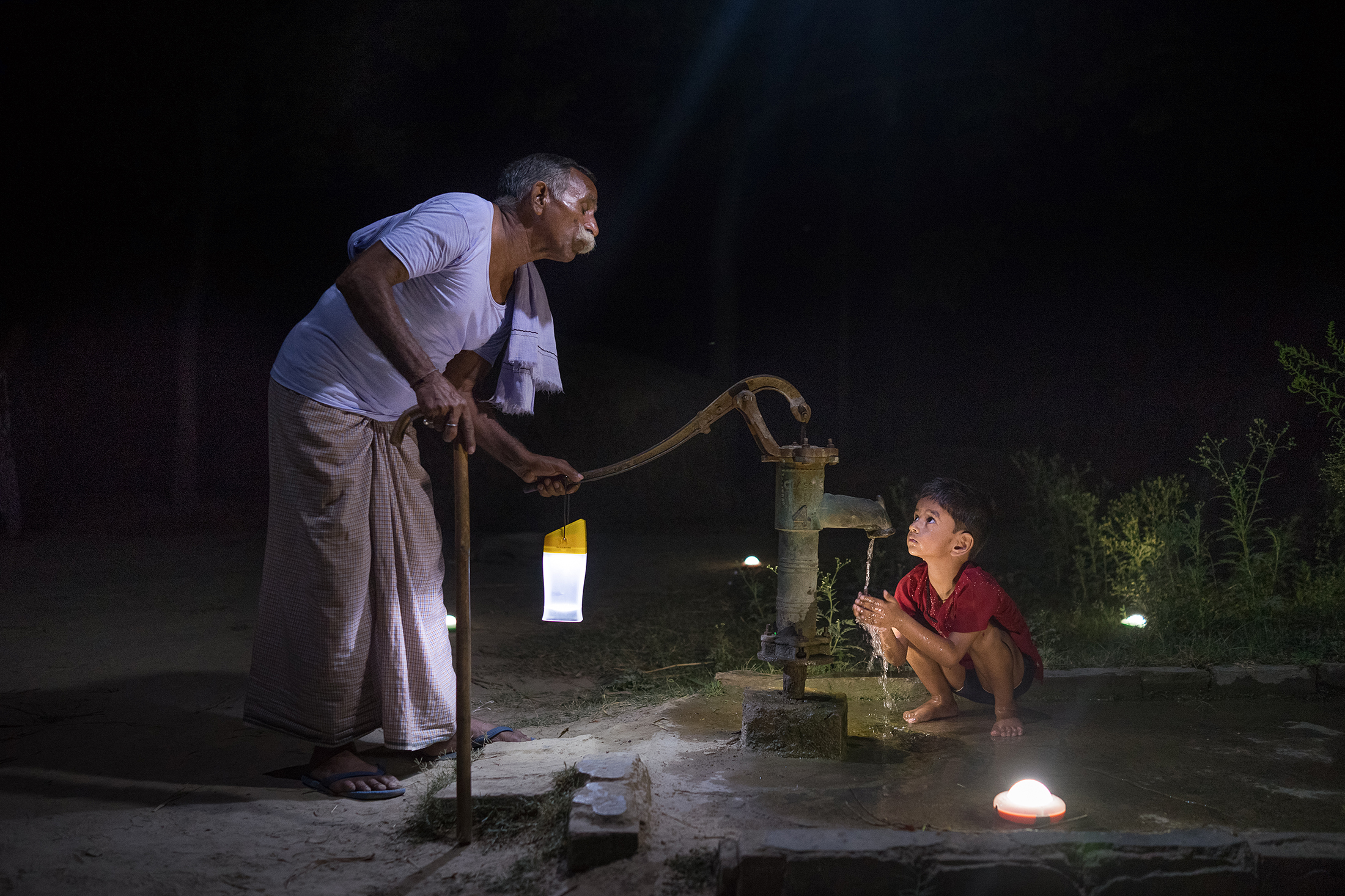 I den indiska byn Pevre Badhai har man varken ledningsvatten eller elektricitet indraget i husen. Men den pensionerade statstjänstemannen Guru Din Shukla och hans barnbarn klarar sig med en manuell vattenpump och solcell-slampor.