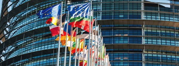 EUs flaggor vajar i solen framför parlamentsbyggnaden i Bryssel.