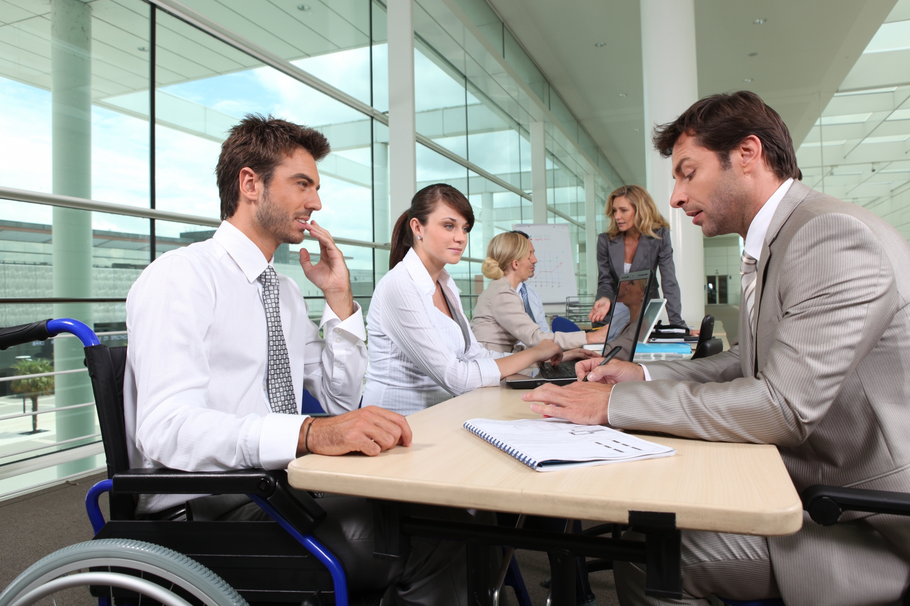 2811414-man-in-wheelchair-working-in-an-office