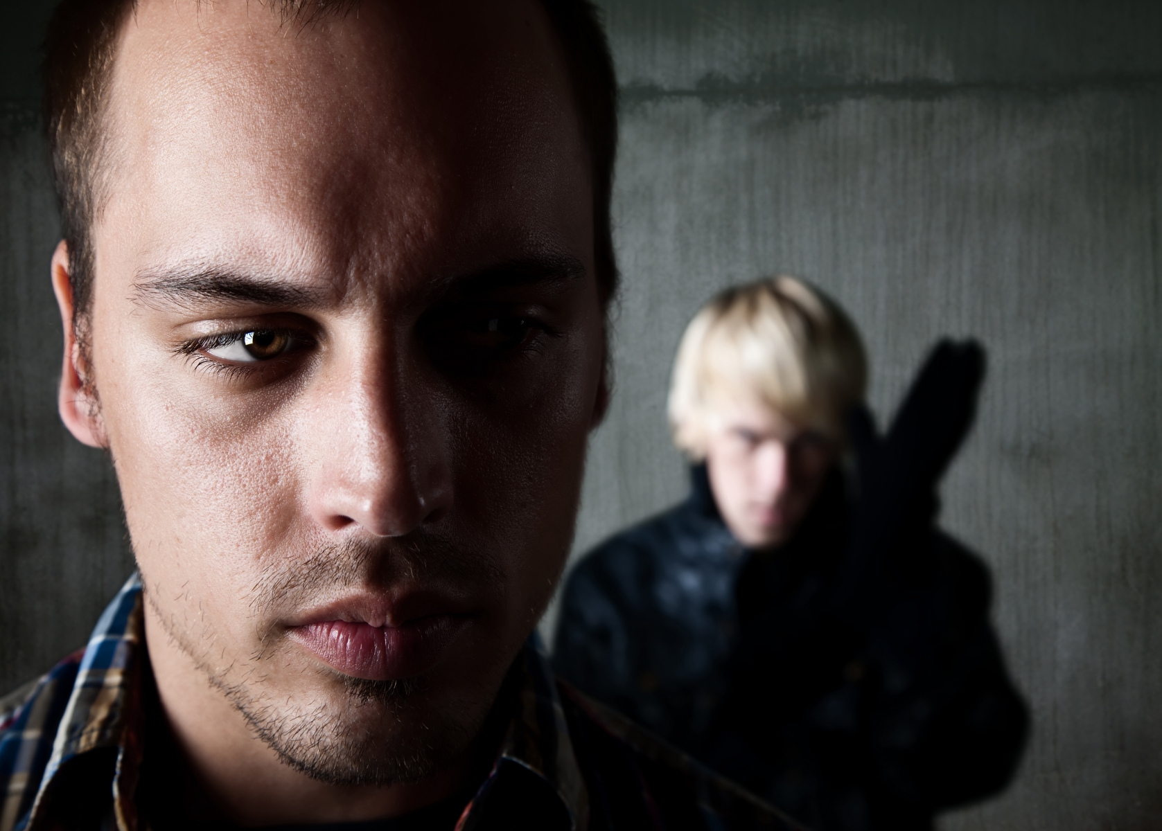 812039-man-being-stalked-by-criminal