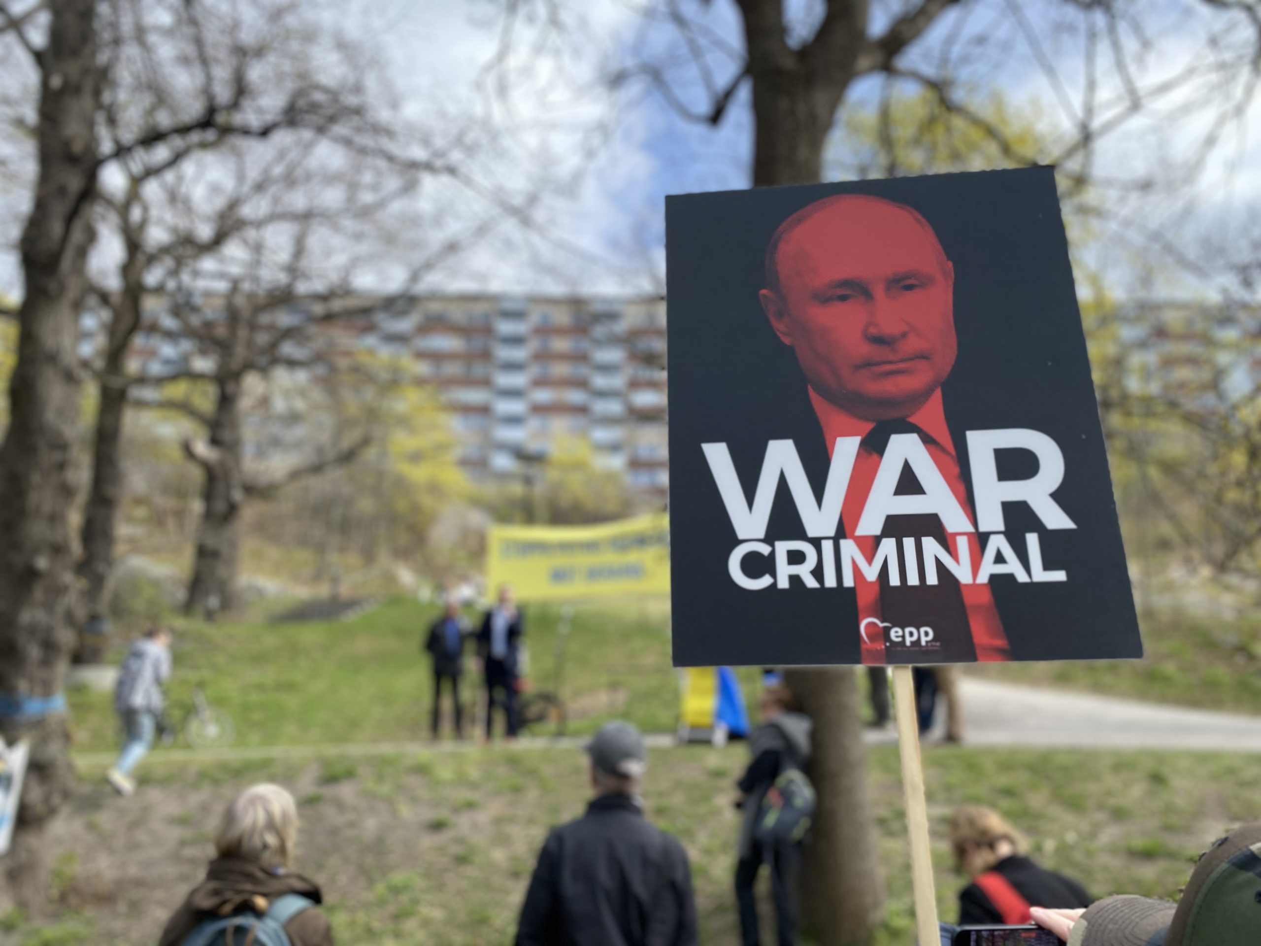 Demonstrationsplakat med en bild på Rysslands president Vladimir Putin och texten "war criminal".
