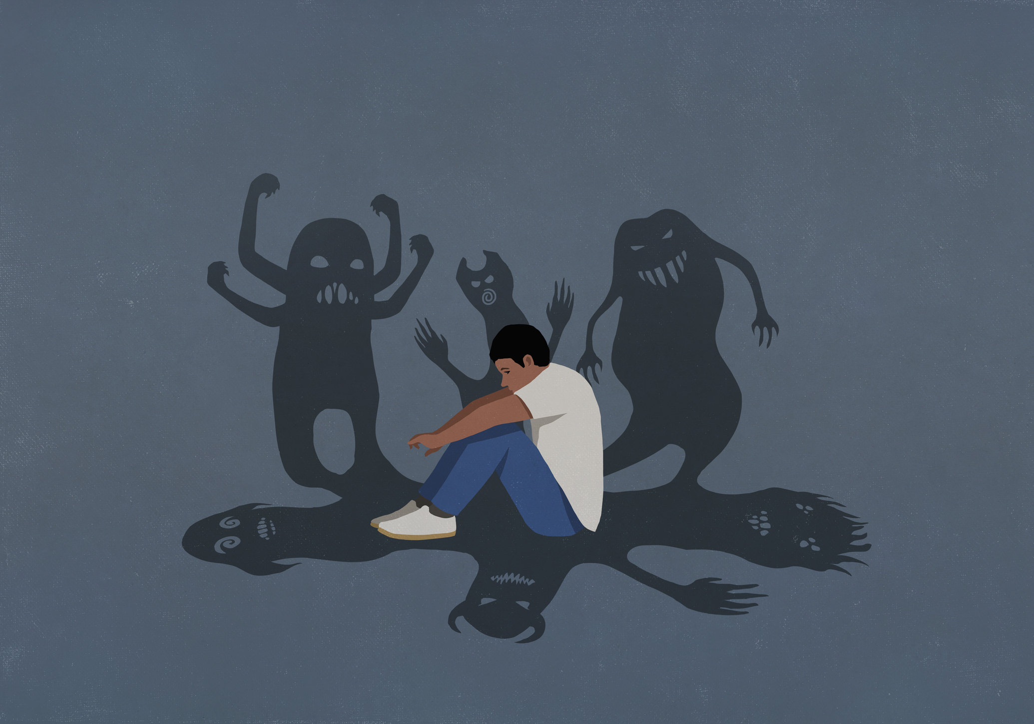 En person sitter på marken med armarna runt knäna, omgiven av figurer som liknar monster mot en grå bakgrund.