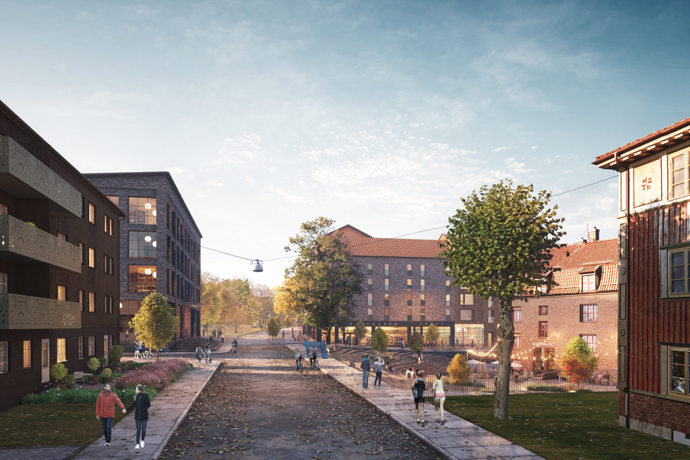 Gatuvy av ett bostadsområde med personer som promenerar, byggnader på båda sidor, träd samt en molnfri himmel.